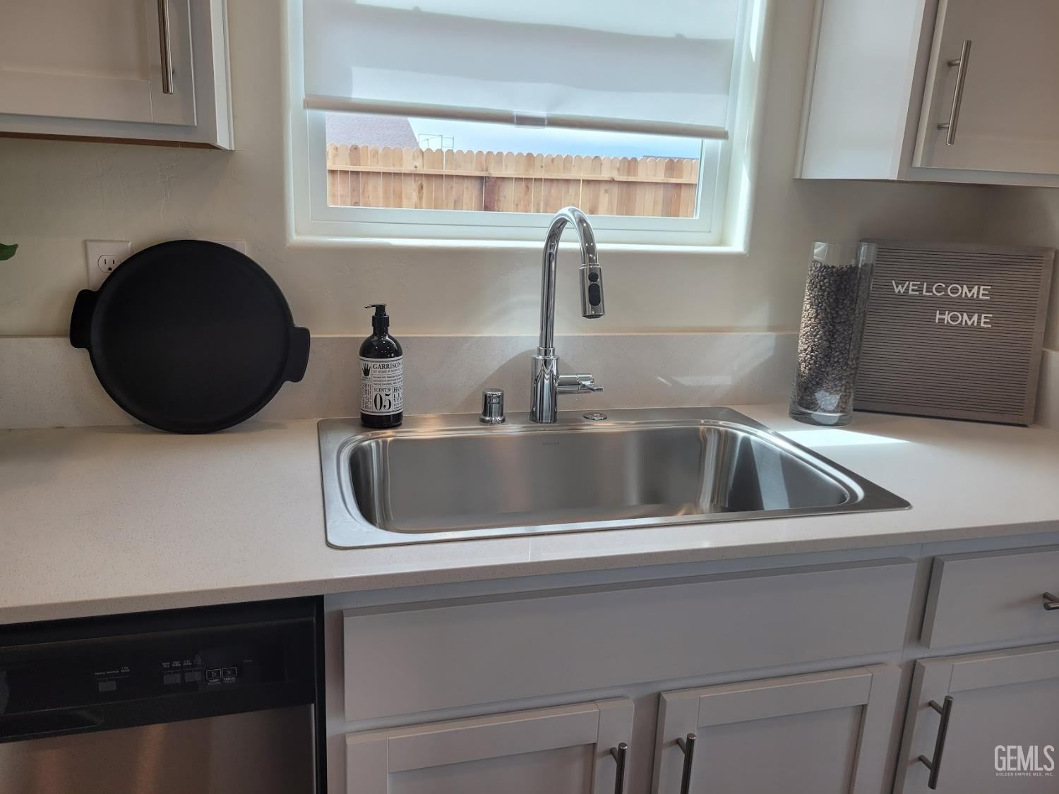 Undisclosed Address Bakersfield, CA 93307 - Photo 12 of 22 a close view of a sink and dishwasher with kitchen island
