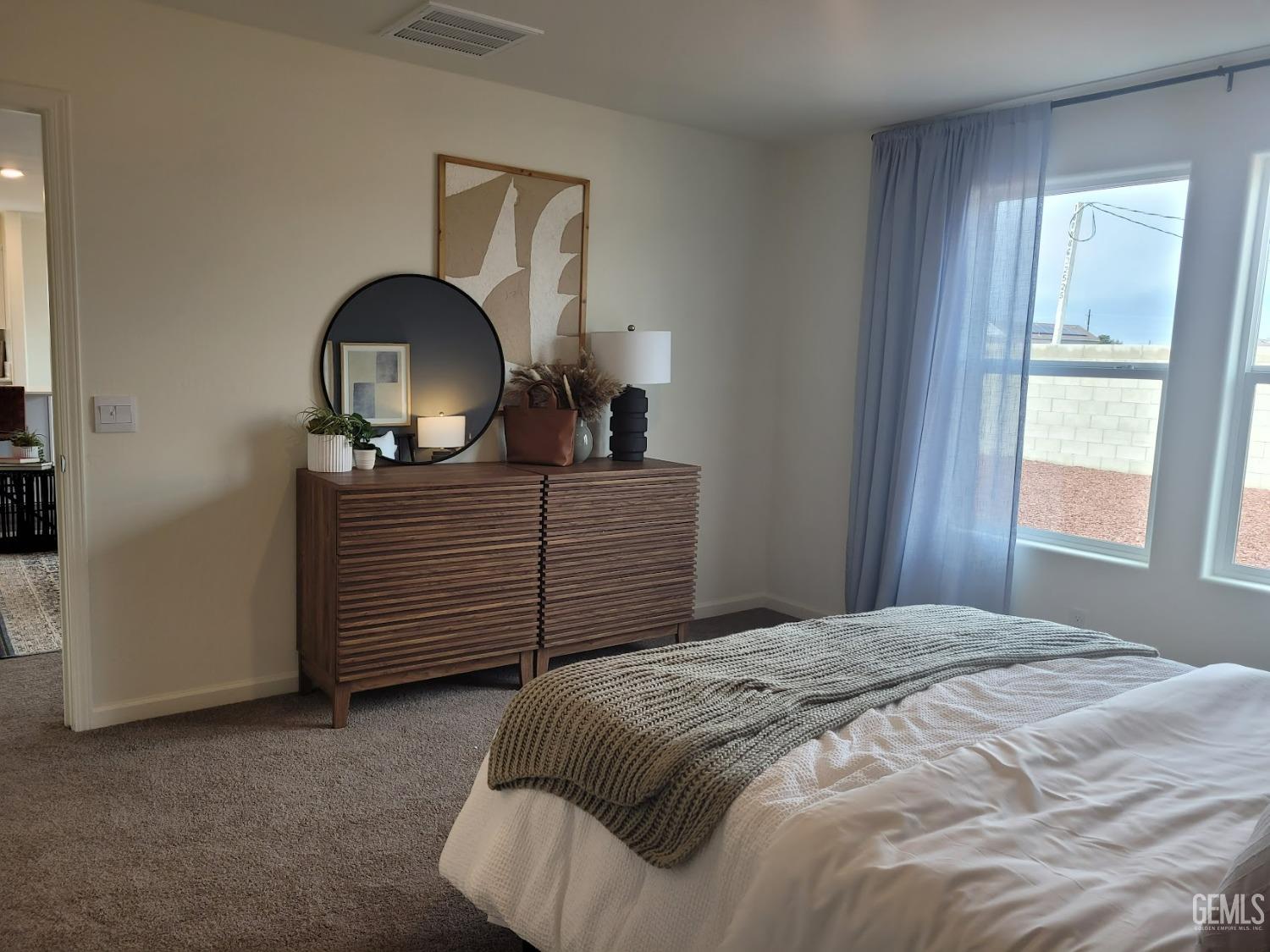 Undisclosed Address Bakersfield, CA 93307 - Photo 17 of 22 a bedroom with a bed and a dresser