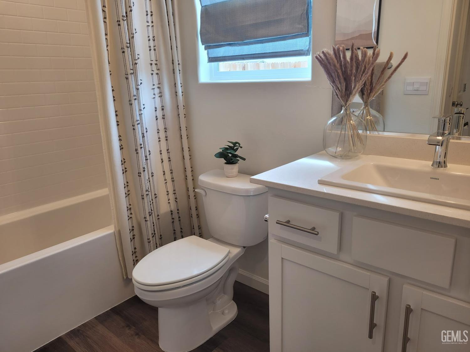 Undisclosed Address Bakersfield, CA 93307 - Photo 9 of 22 a bathroom with a sink a toilet and shower
