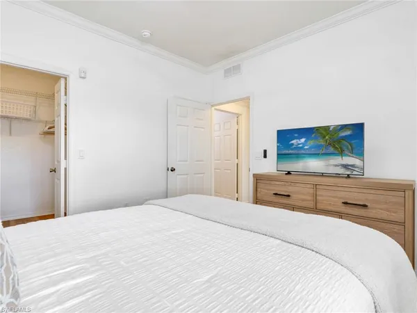 a spacious bedroom with a bed and a cabinets