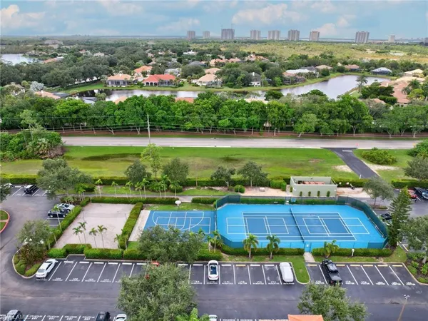 an aerial view of a house with a garden and lake view