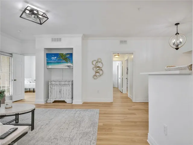 a view of a livingroom with wooden floor and furniture