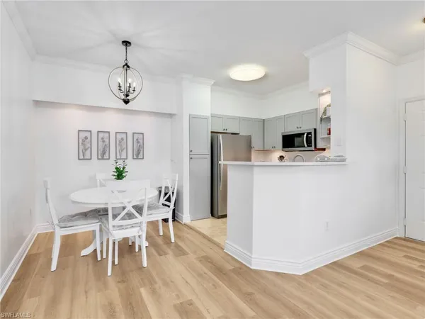 a view of a dining room with furniture wooden floor and chandelier