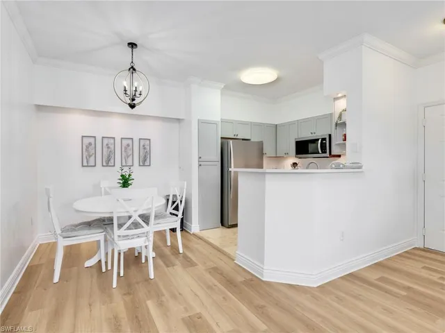 a view of a dining room with furniture wooden floor and chandelier