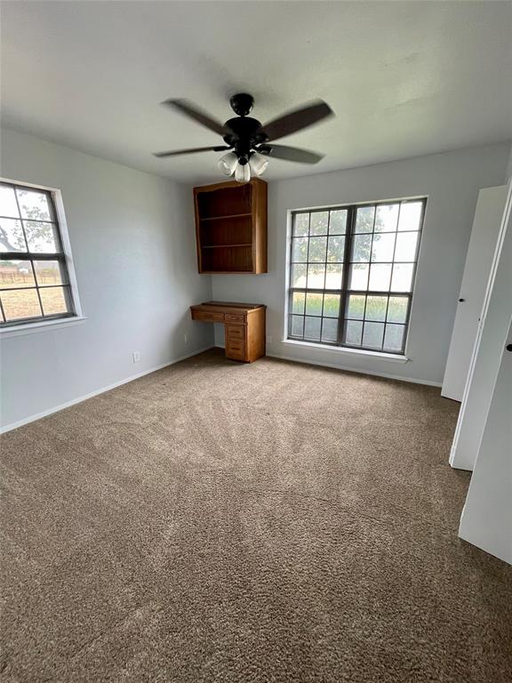 4203 Weiland Road Weatherford, TX 76088 - Photo 12 of 29 an empty room with windows and ceiling fan