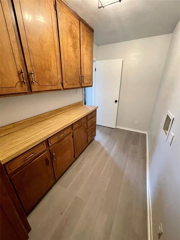 4203 Weiland Road Weatherford, TX 76088 - Photo 18 of 29 a view of a kitchen with wooden floor and cabinets
