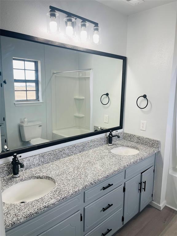 4203 Weiland Road Weatherford, TX 76088 - Photo 20 of 29 a bathroom with a granite countertop sink and a mirror