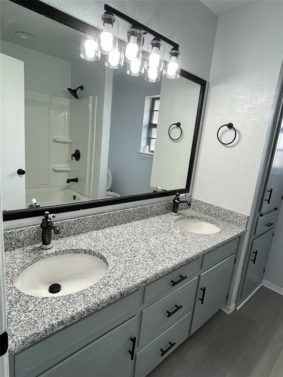 4203 Weiland Road Weatherford, TX 76088 - Photo 9 of 29 a bathroom with a granite countertop sink and a mirror