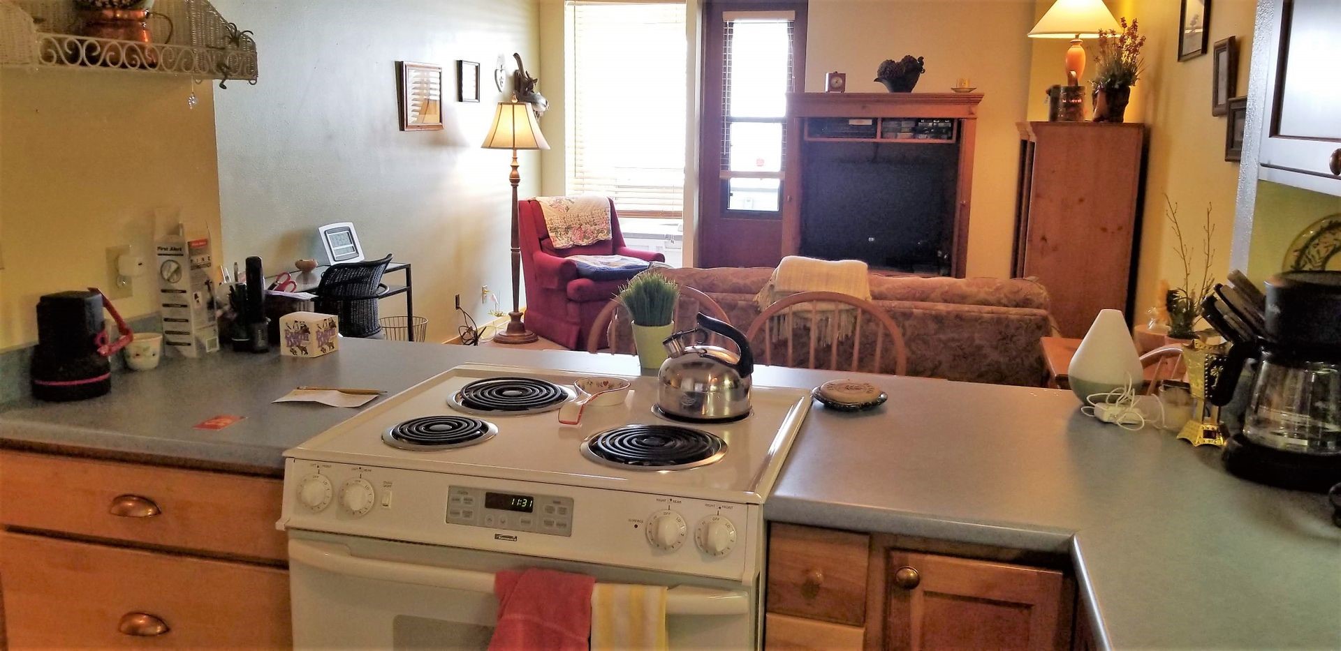 800 Copper Road, Unit 205 Frisco, CO 80443 - Photo 2 of 22 Kitchen with white electric stove and brown cabinets