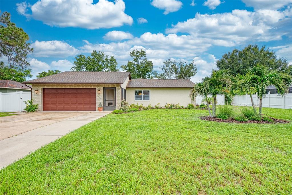 1330 Georgetowne Circle Sarasota, FL 34232 - Photo 1 of 46 a front view of a house with a garden