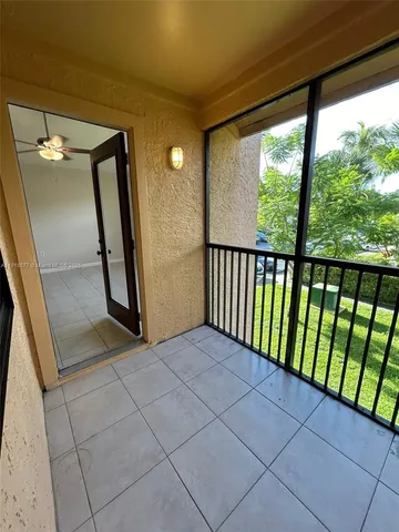 a view of a hallway with wooden floor and stairs