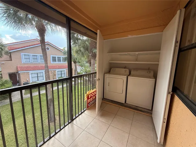 a view of a balcony with washer and dryer