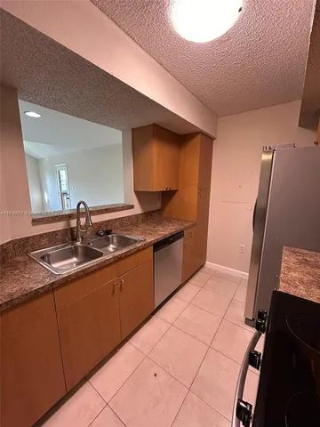 a kitchen with a sink and a refrigerator