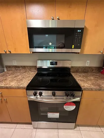 a stove top oven sitting inside of a kitchen