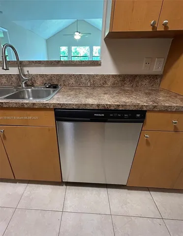 a kitchen with granite countertop a sink and a stove