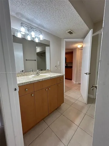 a spacious bathroom with a double vanity sink and a mirror