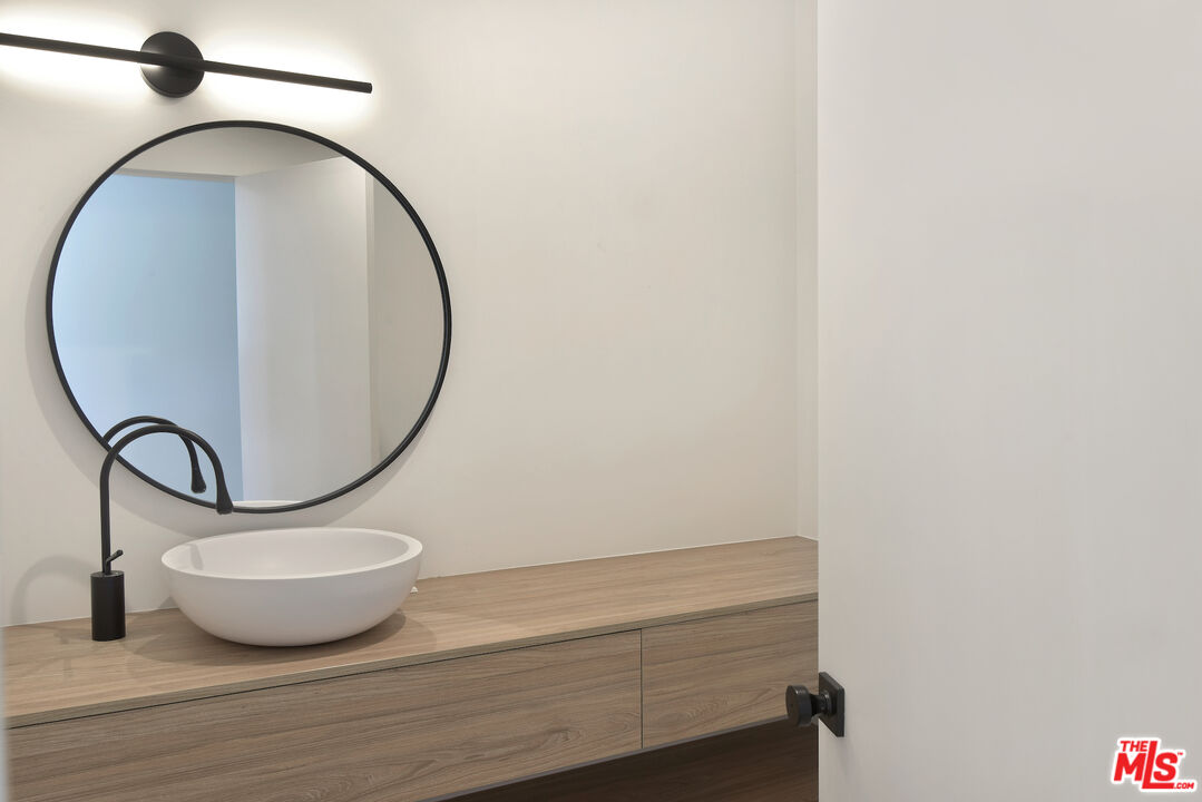 24728 Vantage Point Terrace Malibu, CA 90265 - Photo 26 of 36 a bathroom with a mirror and a gate
