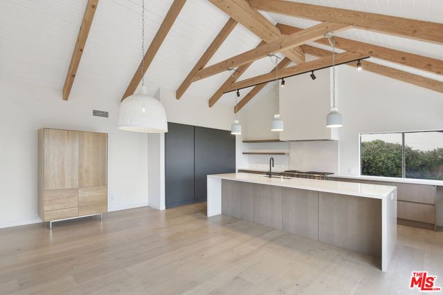 a kitchen with a sink and a stove top oven