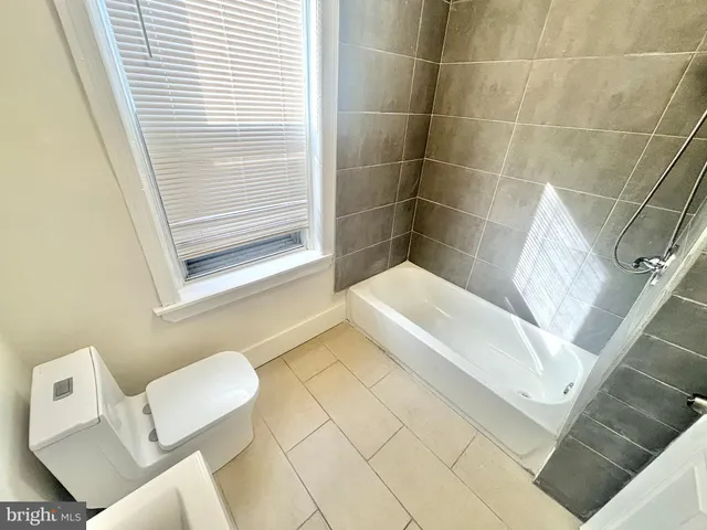 a bathroom with a bathtub and toilet