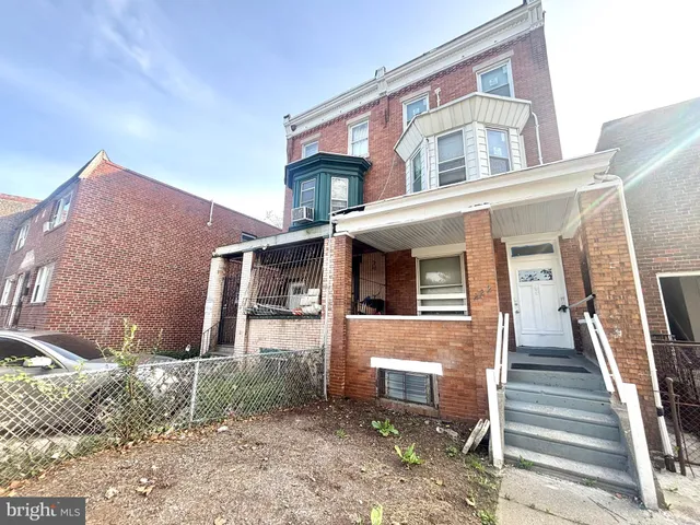 a front view of a house with wooden stairs