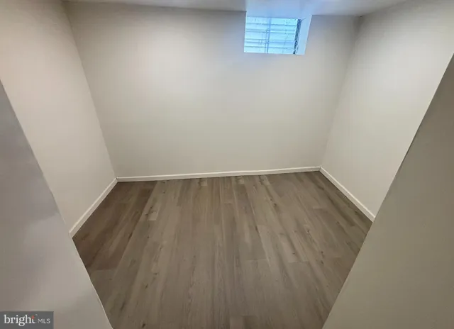 an empty room with wooden floor
