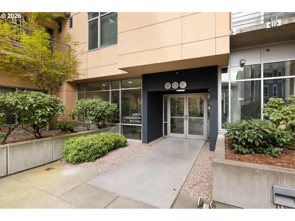 a view of a brick house with potted plants