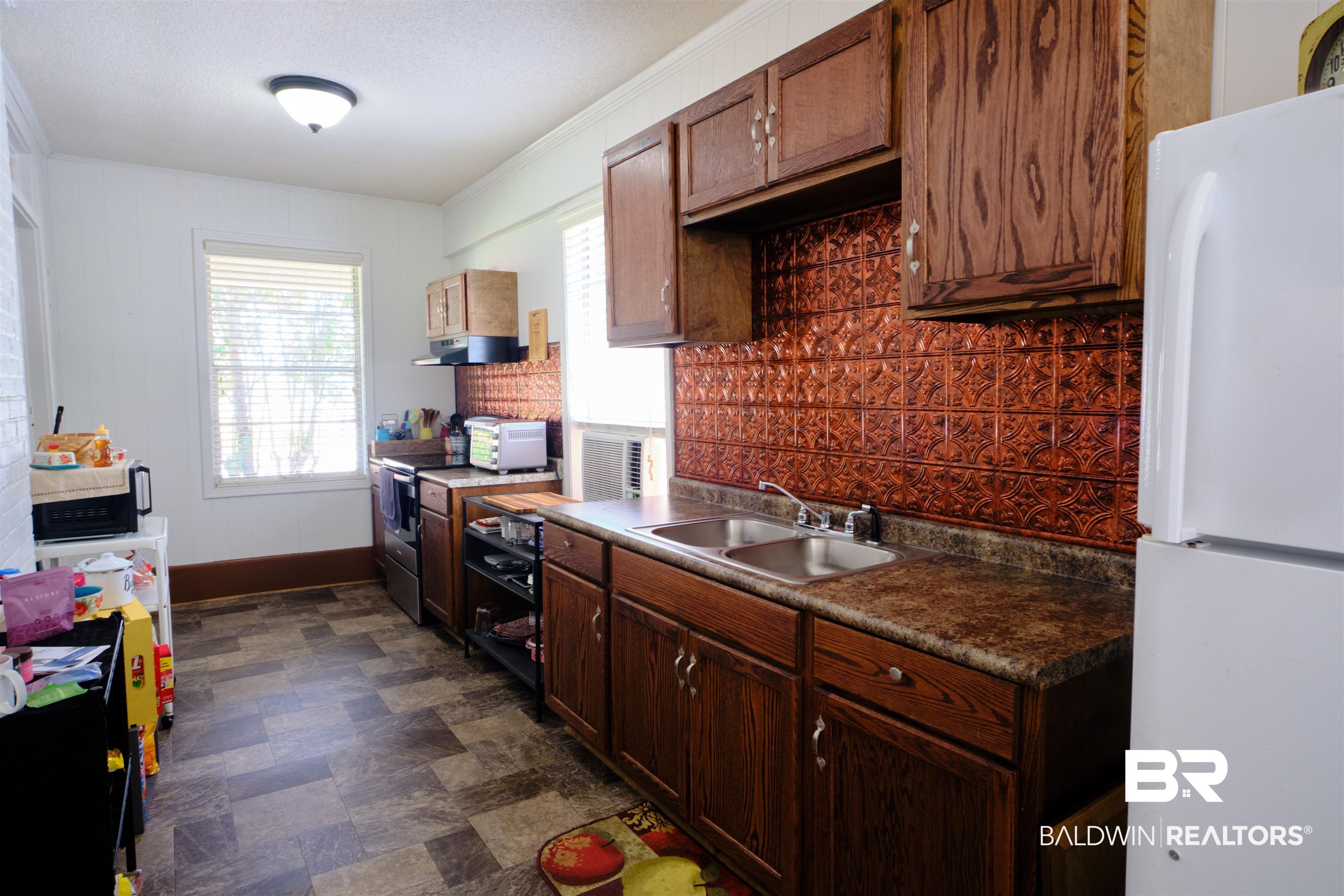 101 West Horner Street Atmore, AL 36502 - Photo 24 of 38 Kitchen featuring stainless steel electric range oven, sink, dark tile patterned floors, and white refrigerator