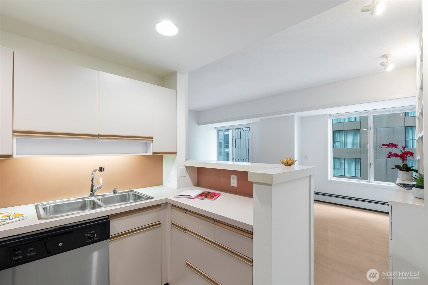 98 Union Street, Unit 408 Seattle, WA 98101 - Photo 12 of 30 a kitchen that has a sink and cabinets in it
