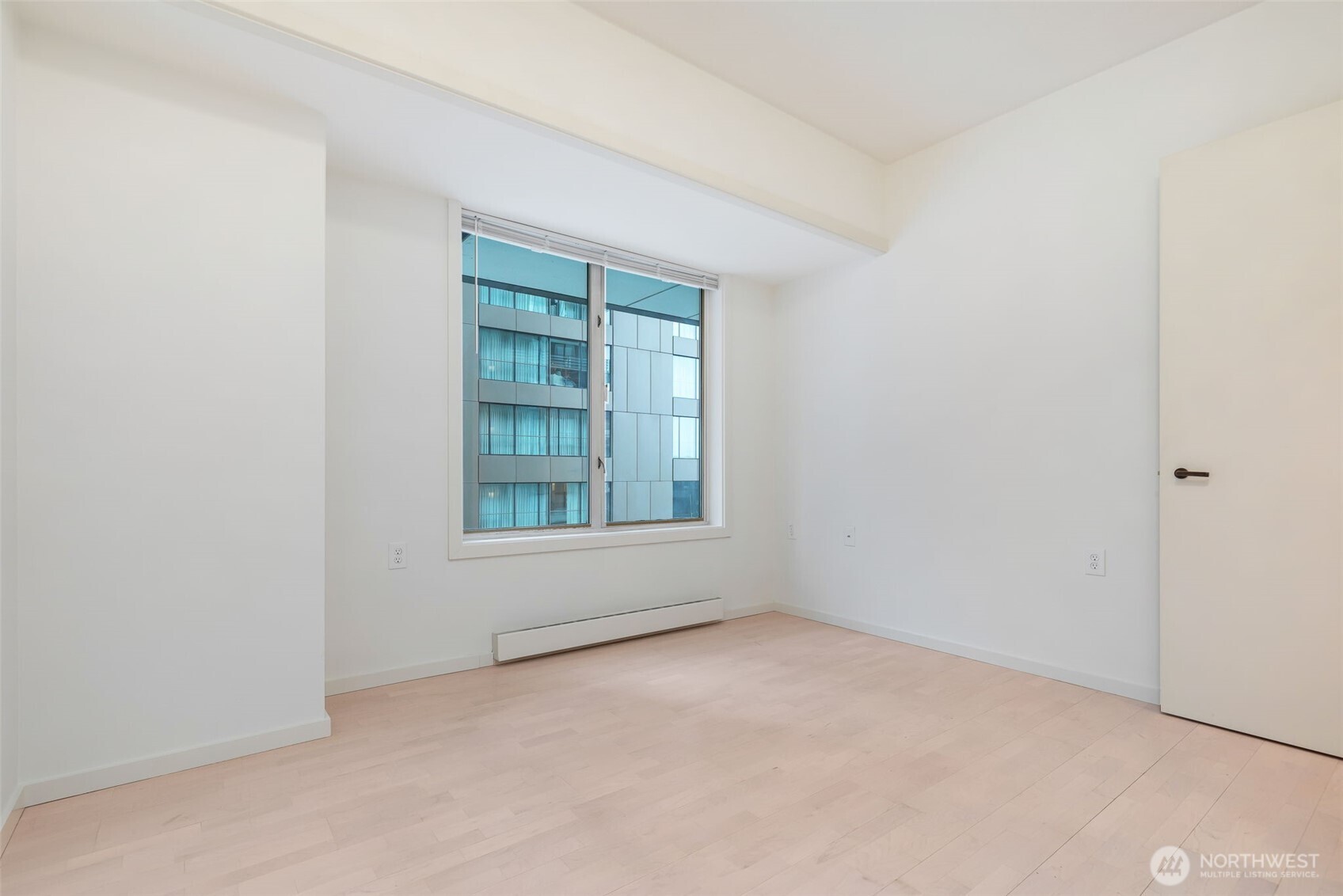 98 Union Street, Unit 408 Seattle, WA 98101 - Photo 16 of 30 an empty room with windows