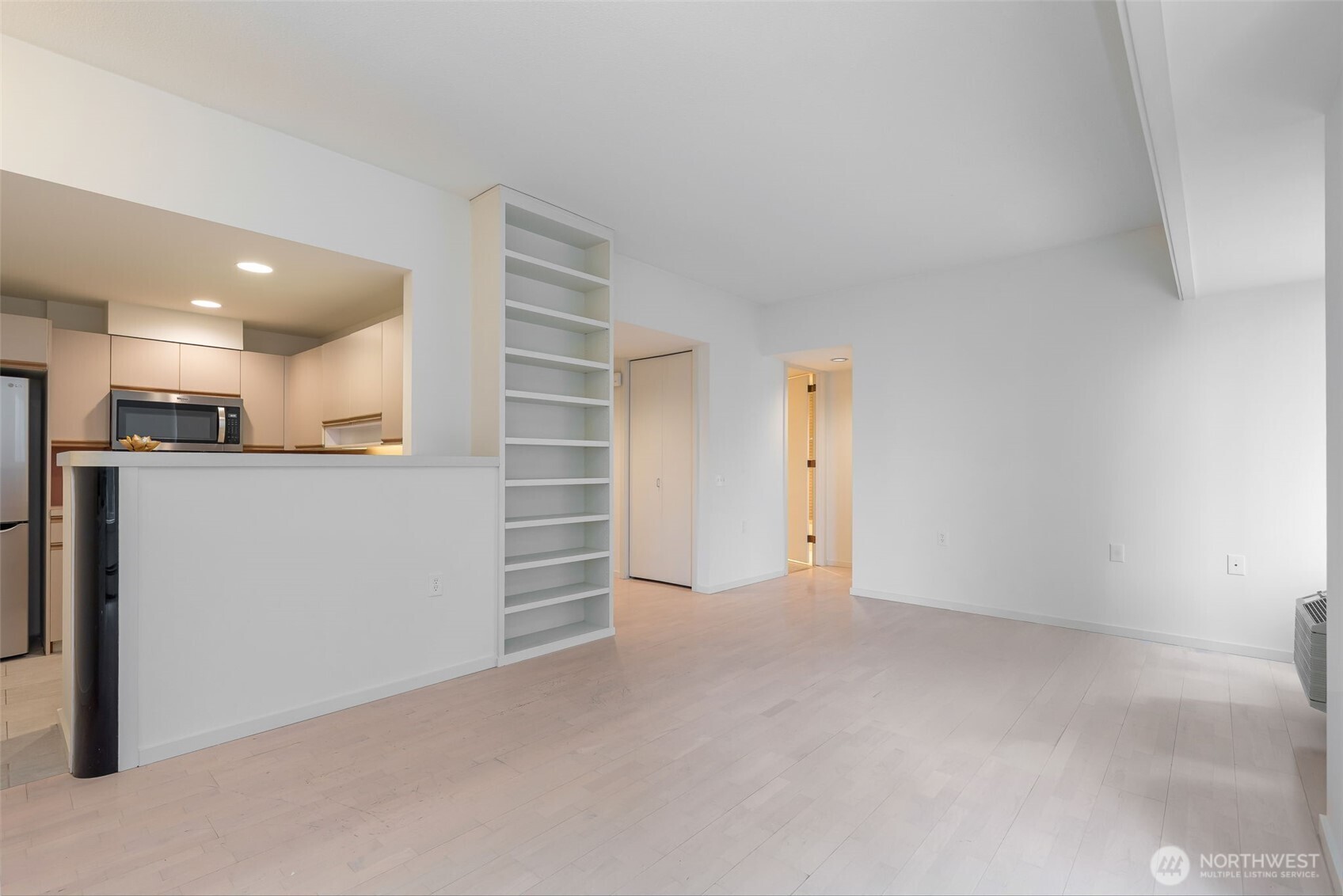 98 Union Street, Unit 408 Seattle, WA 98101 - Photo 8 of 30 a view of an empty room with a kitchen
