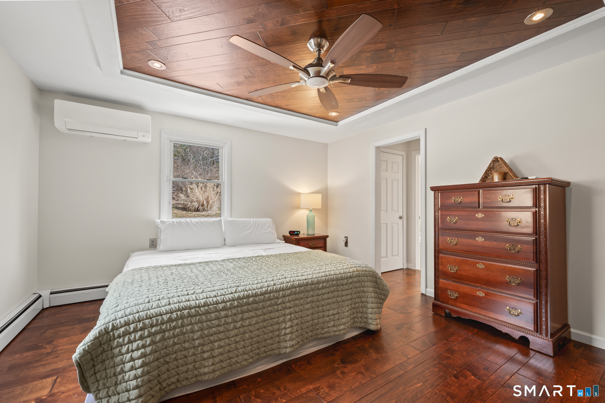 64 Westford Road Eastford, CT 06242 - Photo 20 of 40 a bedroom with a bed and a chandelier