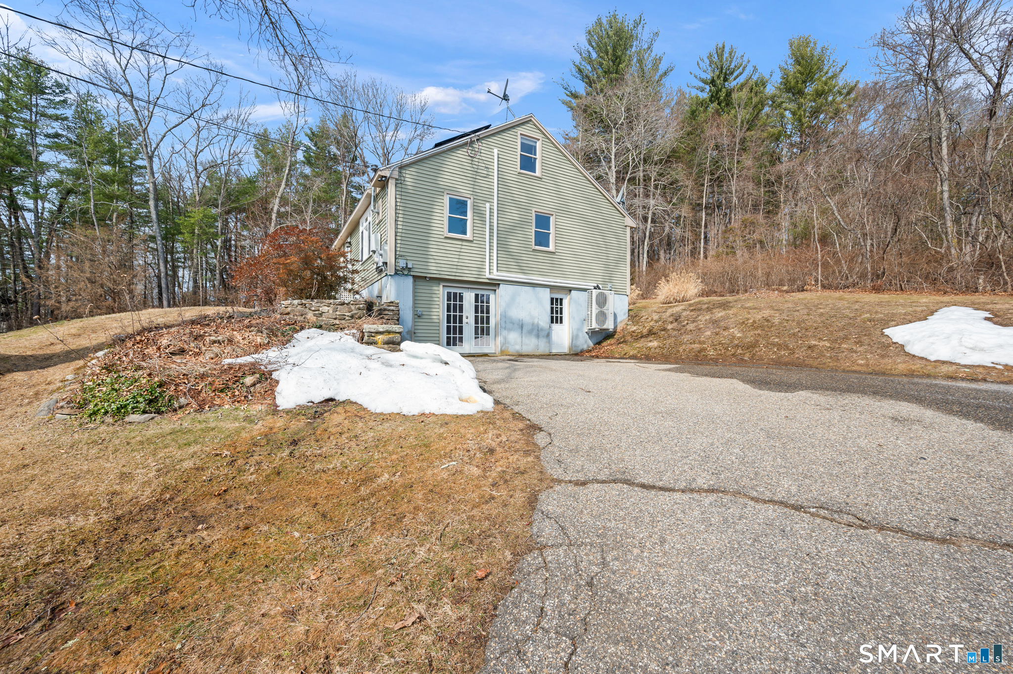 64 Westford Road Eastford, CT 06242 - Photo 2 of 40 a front view of a house with a yard covered with snow