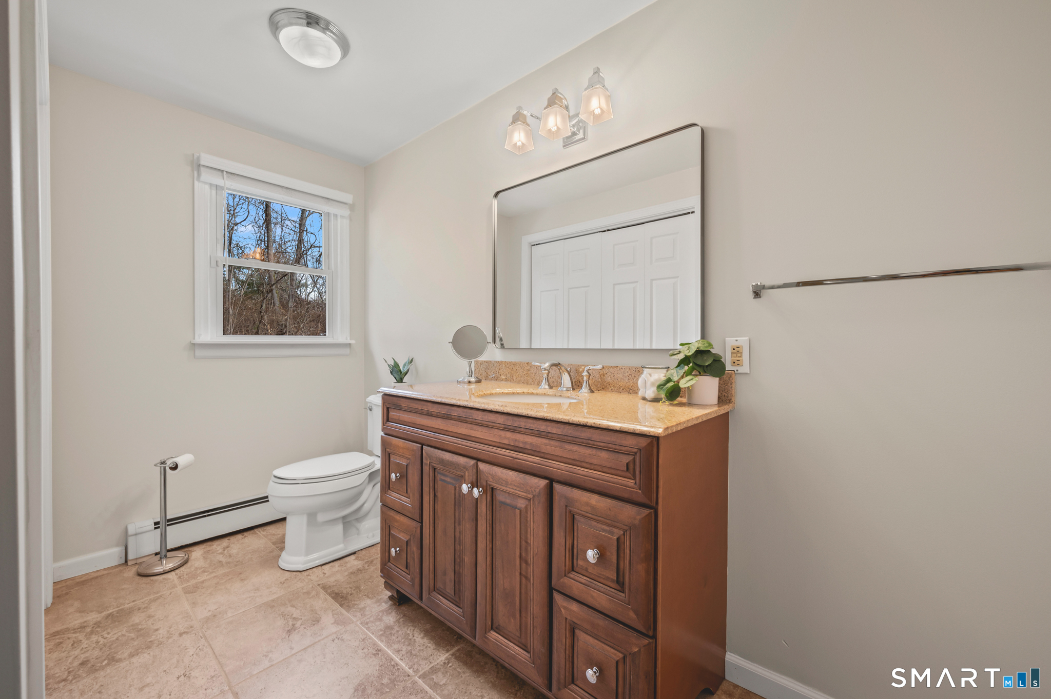 64 Westford Road Eastford, CT 06242 - Photo 21 of 40 a bathroom with a toilet a sink and mirror