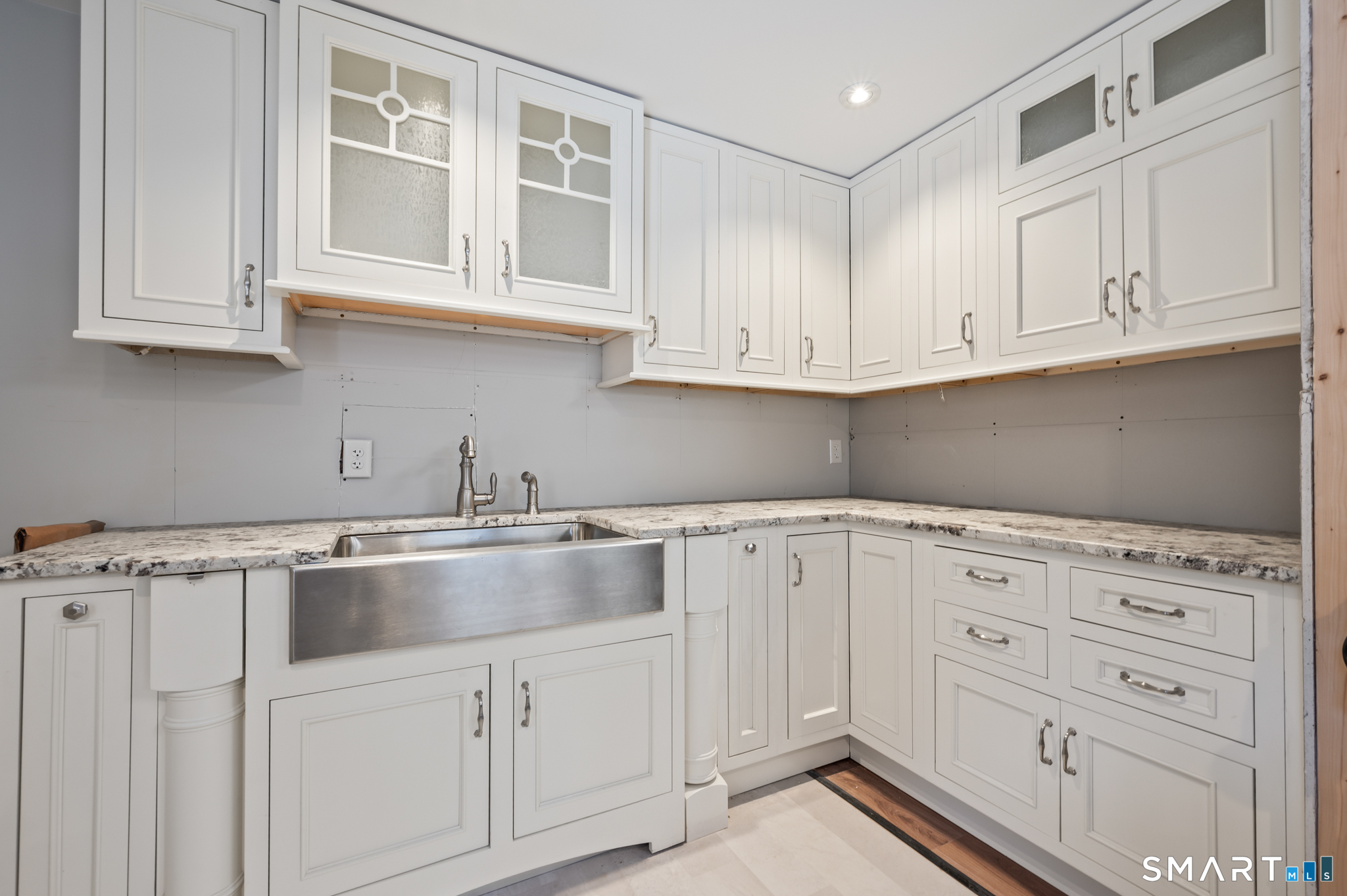64 Westford Road Eastford, CT 06242 - Photo 37 of 40 a kitchen with granite countertop white cabinets and sink