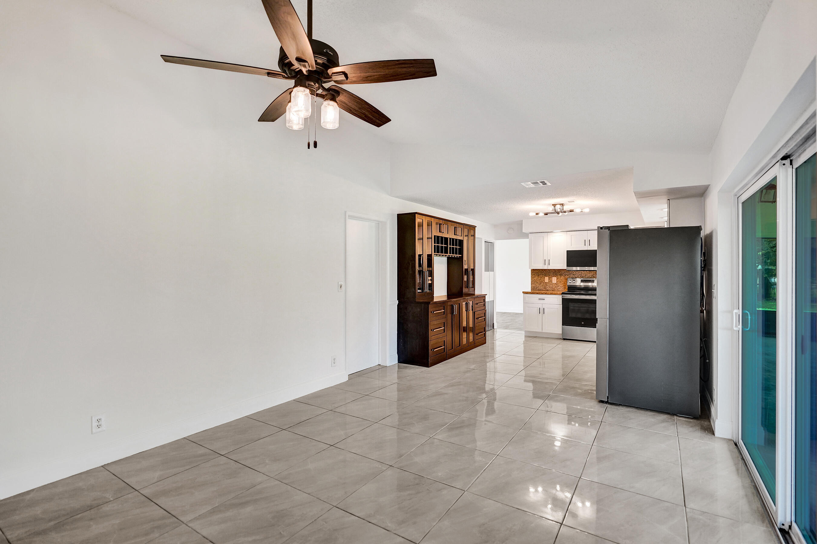 9855 Robins Nest Road Boca Raton, FL 33496 - Photo 12 of 84 a kitchen with stainless steel appliances a refrigerator and a stove top oven