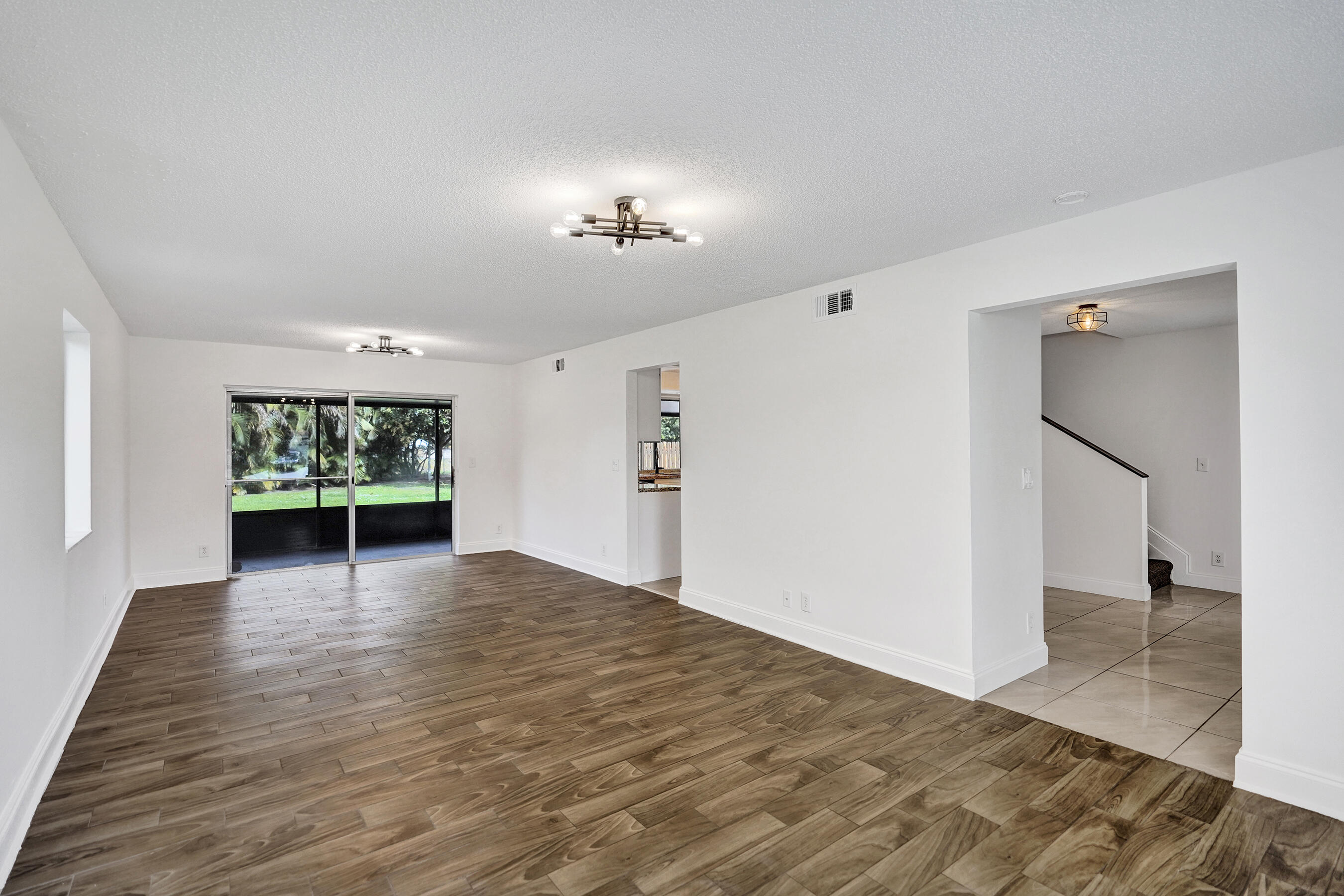 9855 Robins Nest Road Boca Raton, FL 33496 - Photo 14 of 84 a view of an empty room with a window and a fireplace