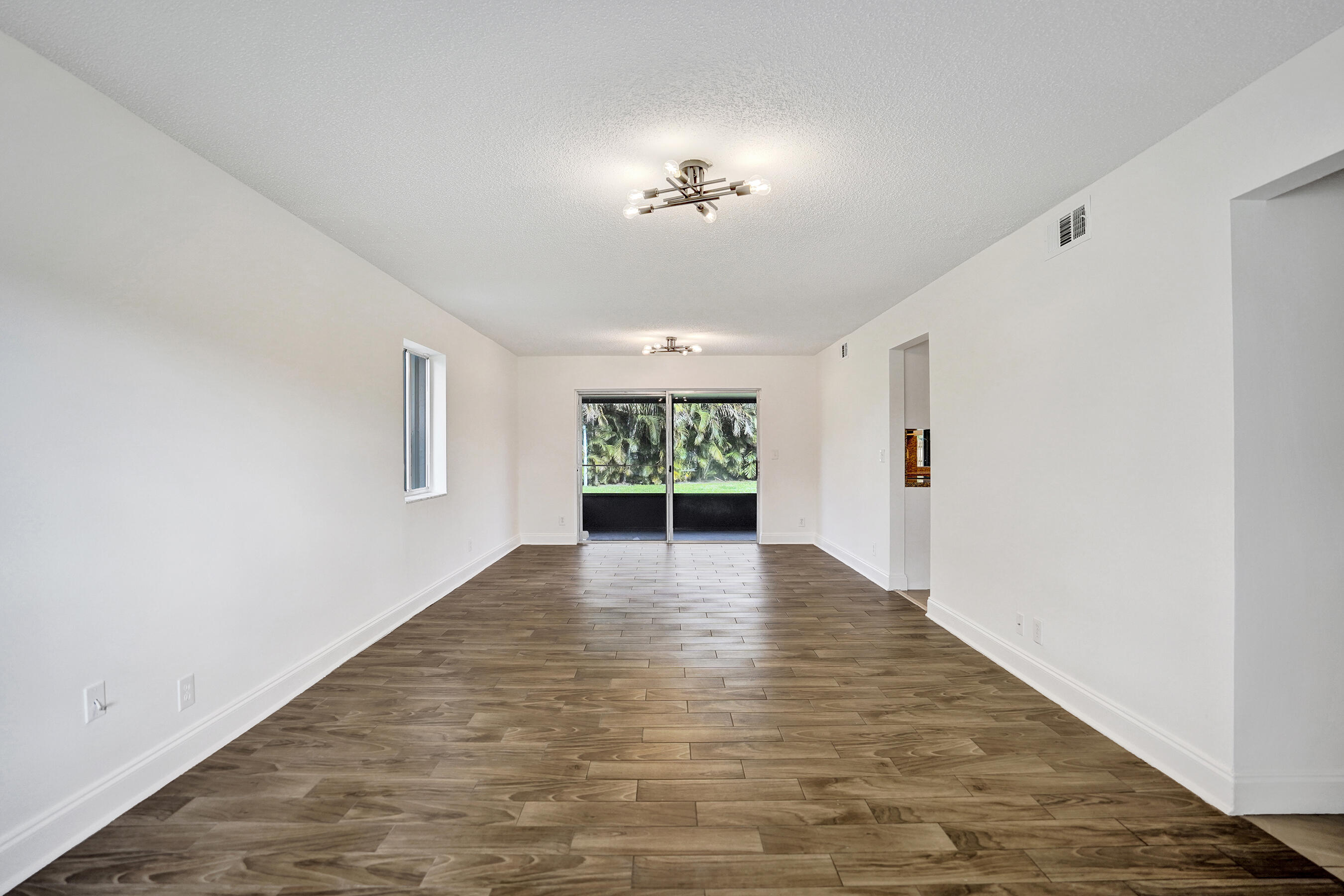 9855 Robins Nest Road Boca Raton, FL 33496 - Photo 16 of 84 wooden floor in an empty room with a window