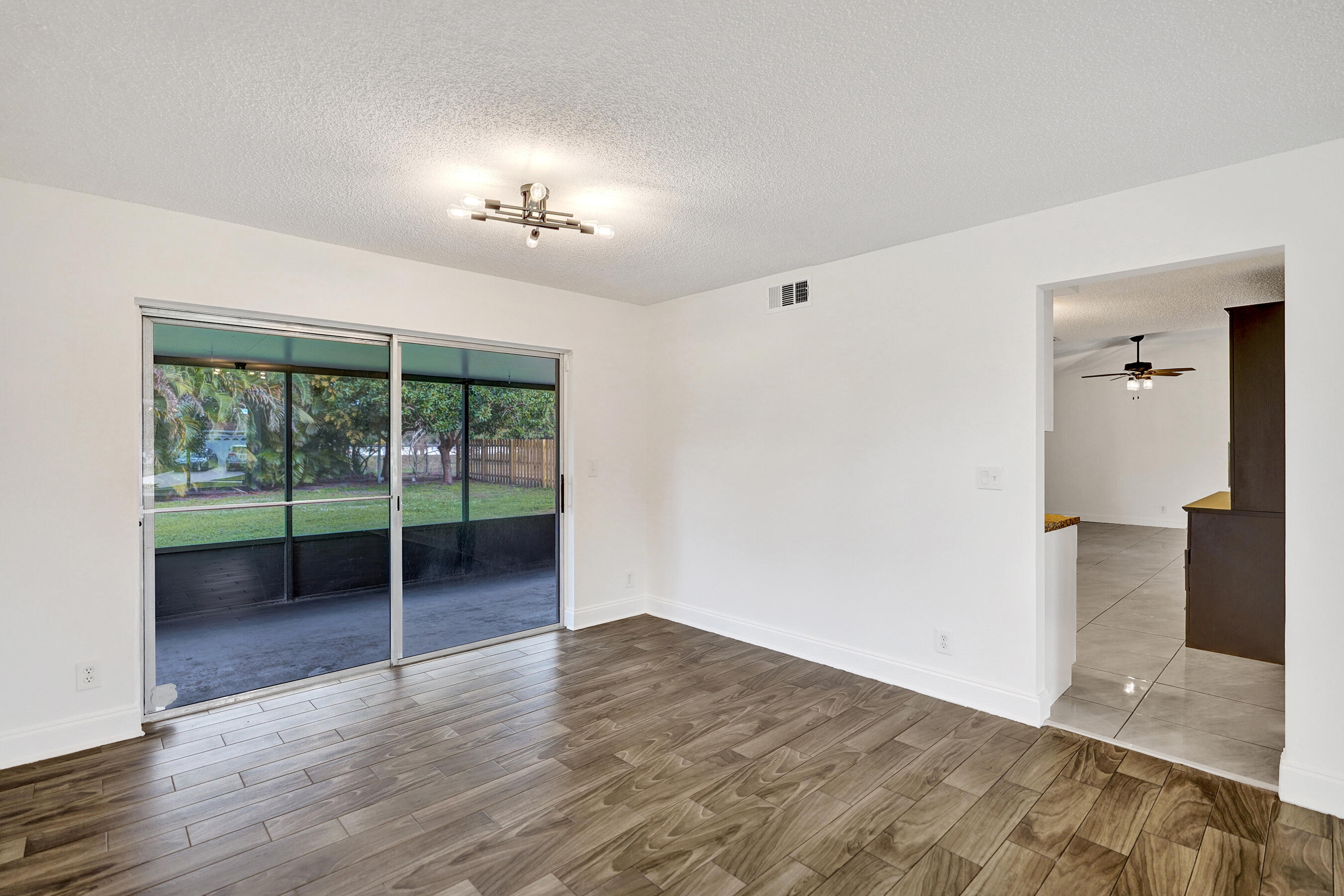 9855 Robins Nest Road Boca Raton, FL 33496 - Photo 18 of 84 wooden floor in an empty room with a window