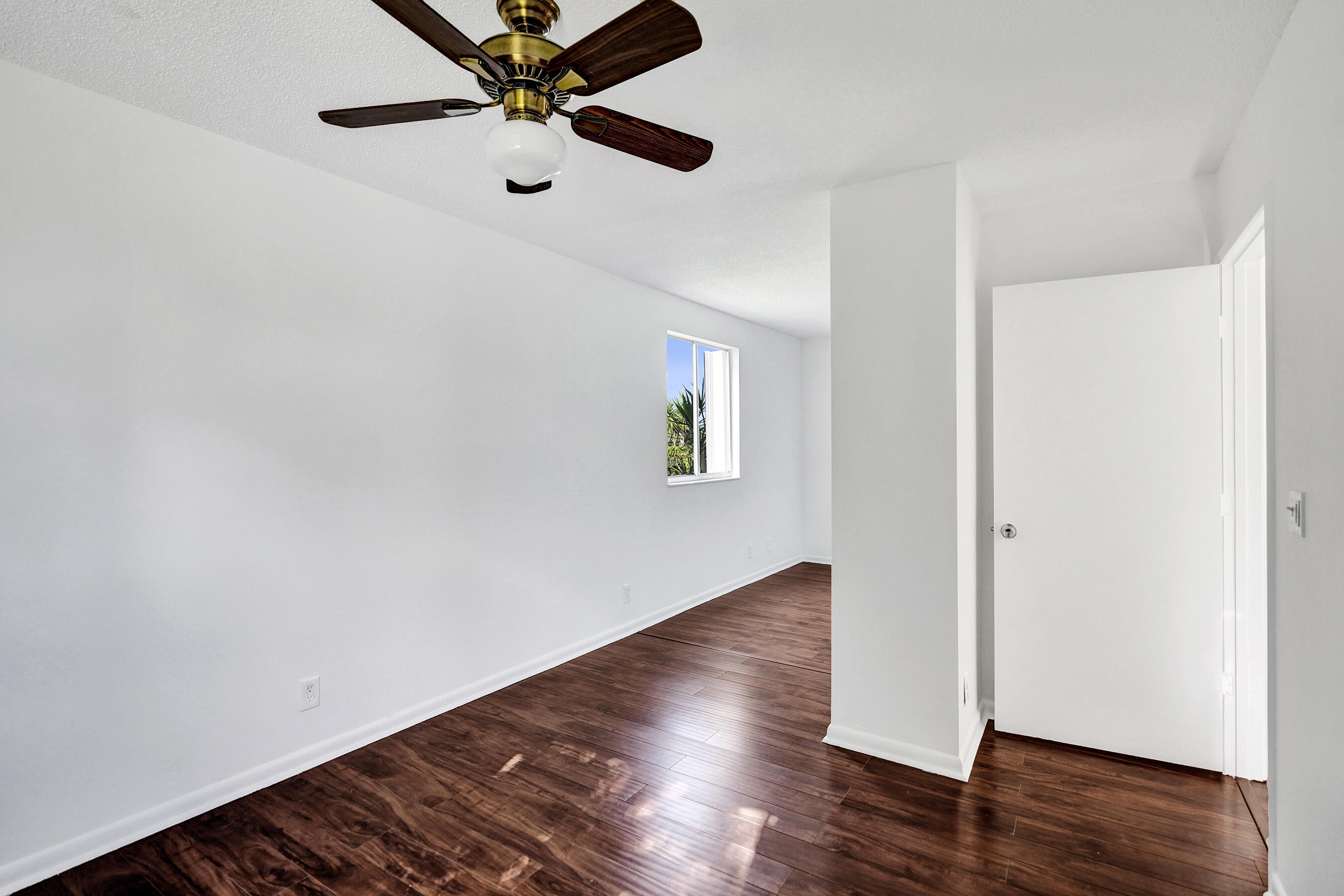 9855 Robins Nest Road Boca Raton, FL 33496 - Photo 31 of 84 a view of an empty room with wooden floor