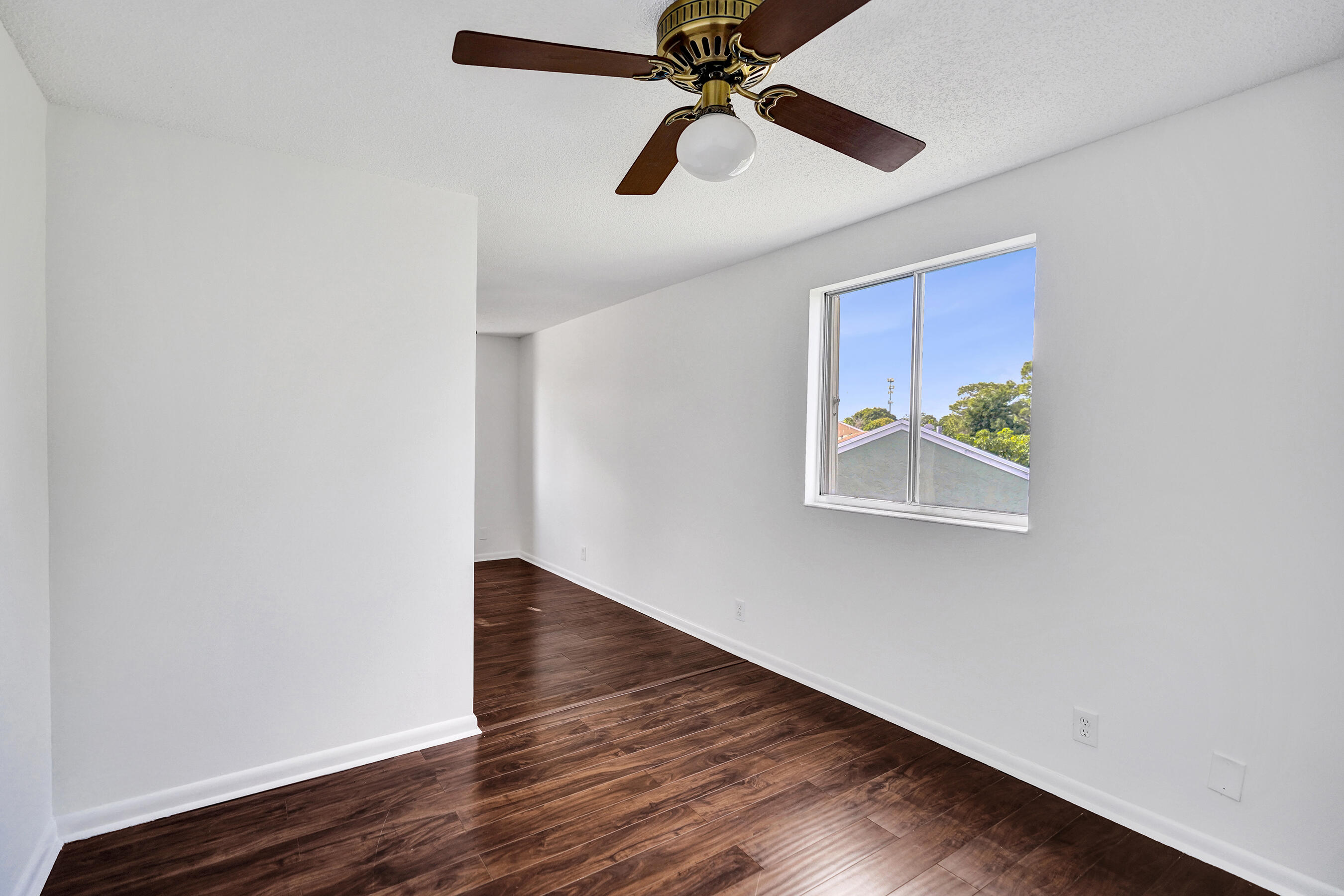 9855 Robins Nest Road Boca Raton, FL 33496 - Photo 34 of 84 an empty room with wooden floor closet and fan