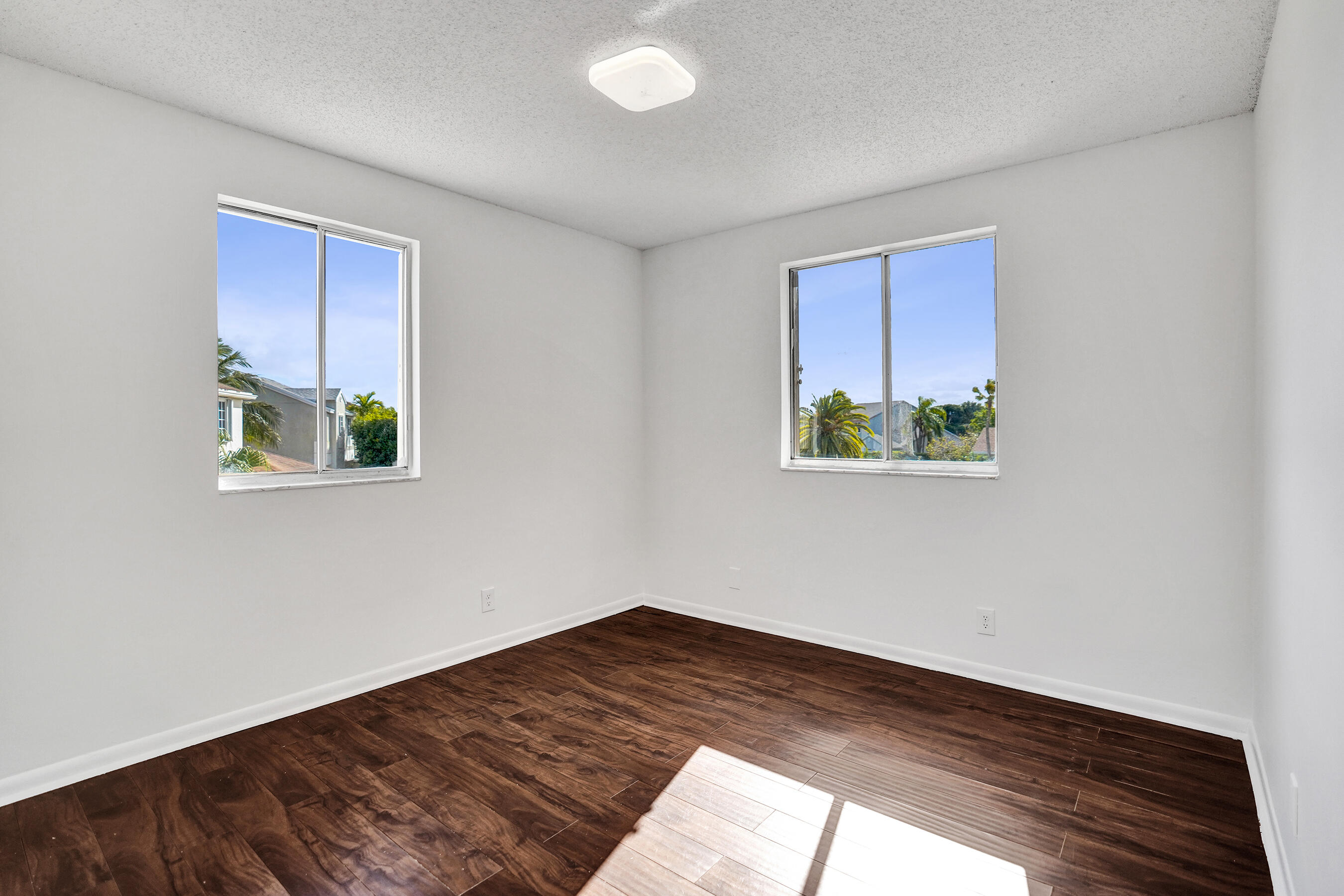 9855 Robins Nest Road Boca Raton, FL 33496 - Photo 36 of 84 a view of a big room with wooden floor and windows