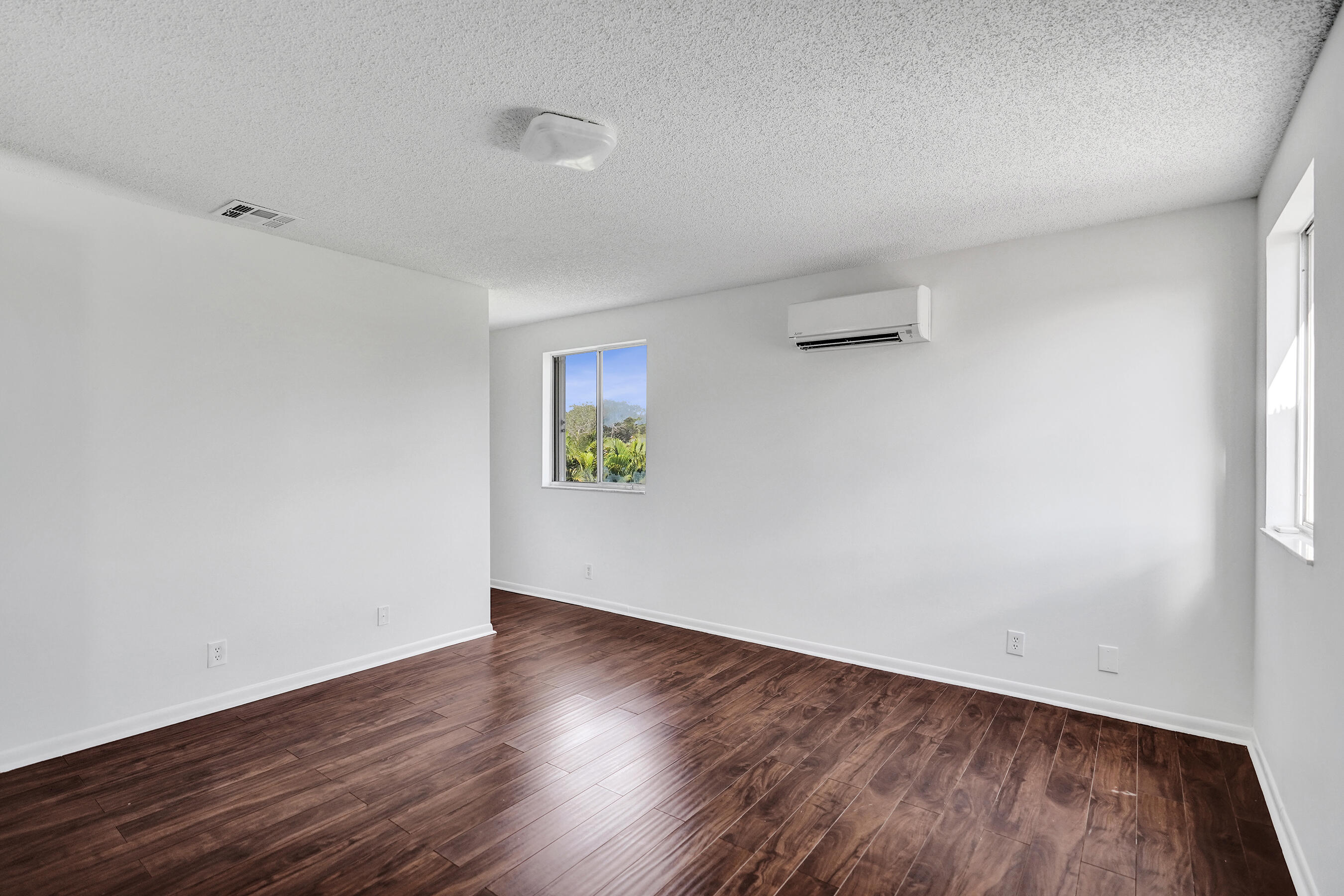 9855 Robins Nest Road Boca Raton, FL 33496 - Photo 41 of 84 an empty room with wooden floor and a window