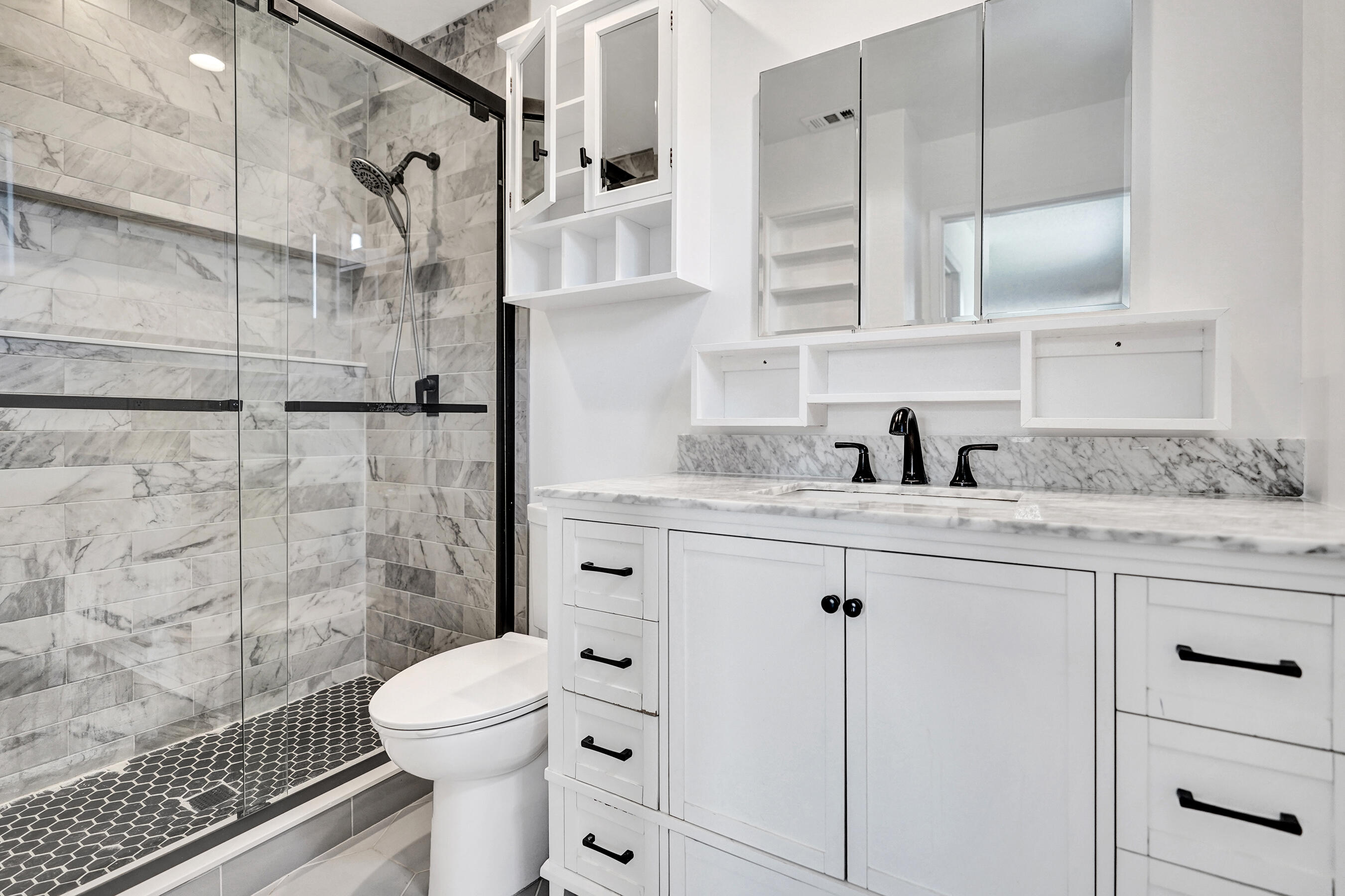 9855 Robins Nest Road Boca Raton, FL 33496 - Photo 45 of 84 a bathroom with a granite countertop sink a toilet and shower