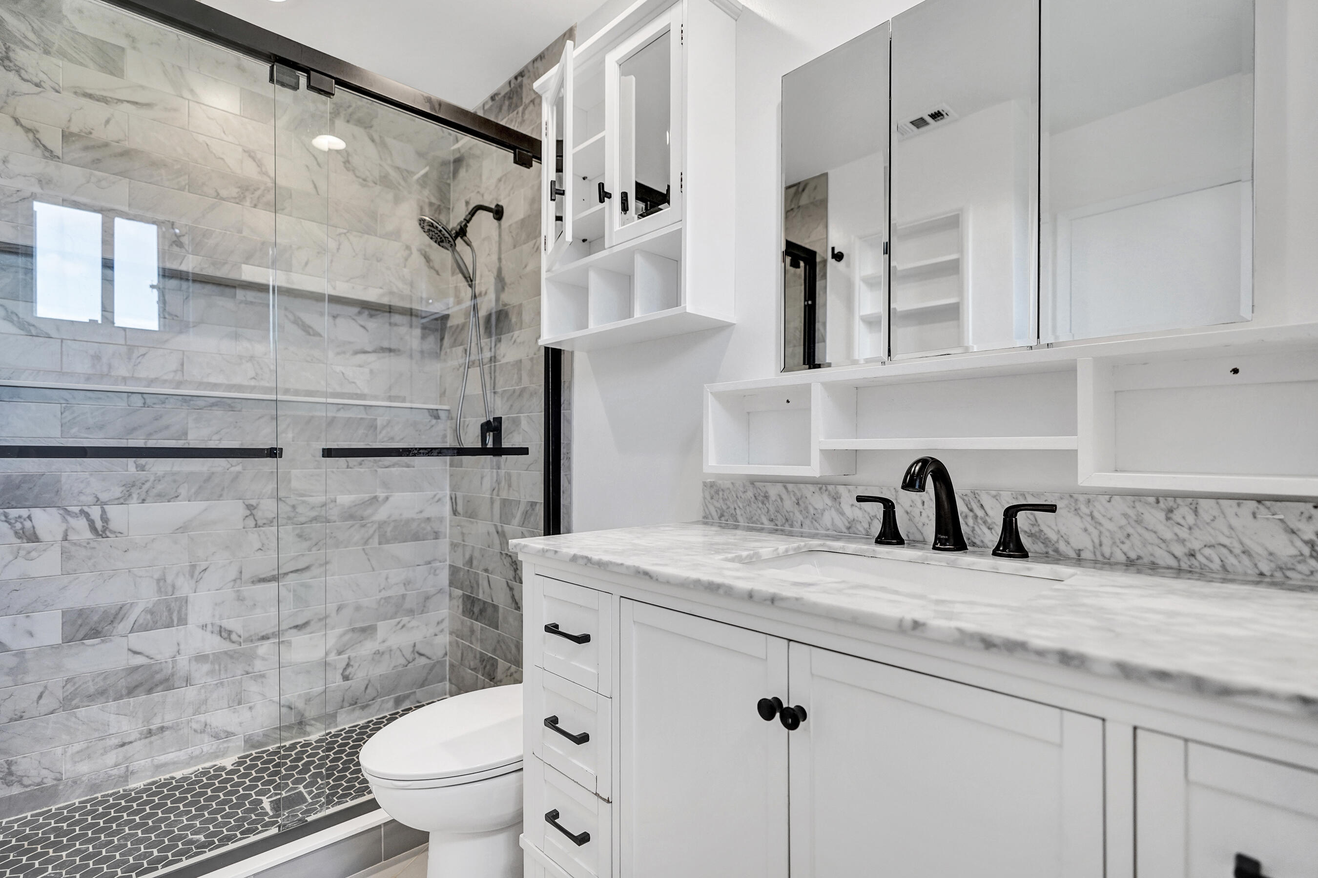 9855 Robins Nest Road Boca Raton, FL 33496 - Photo 46 of 84 a bathroom with a granite countertop sink a toilet and a shower