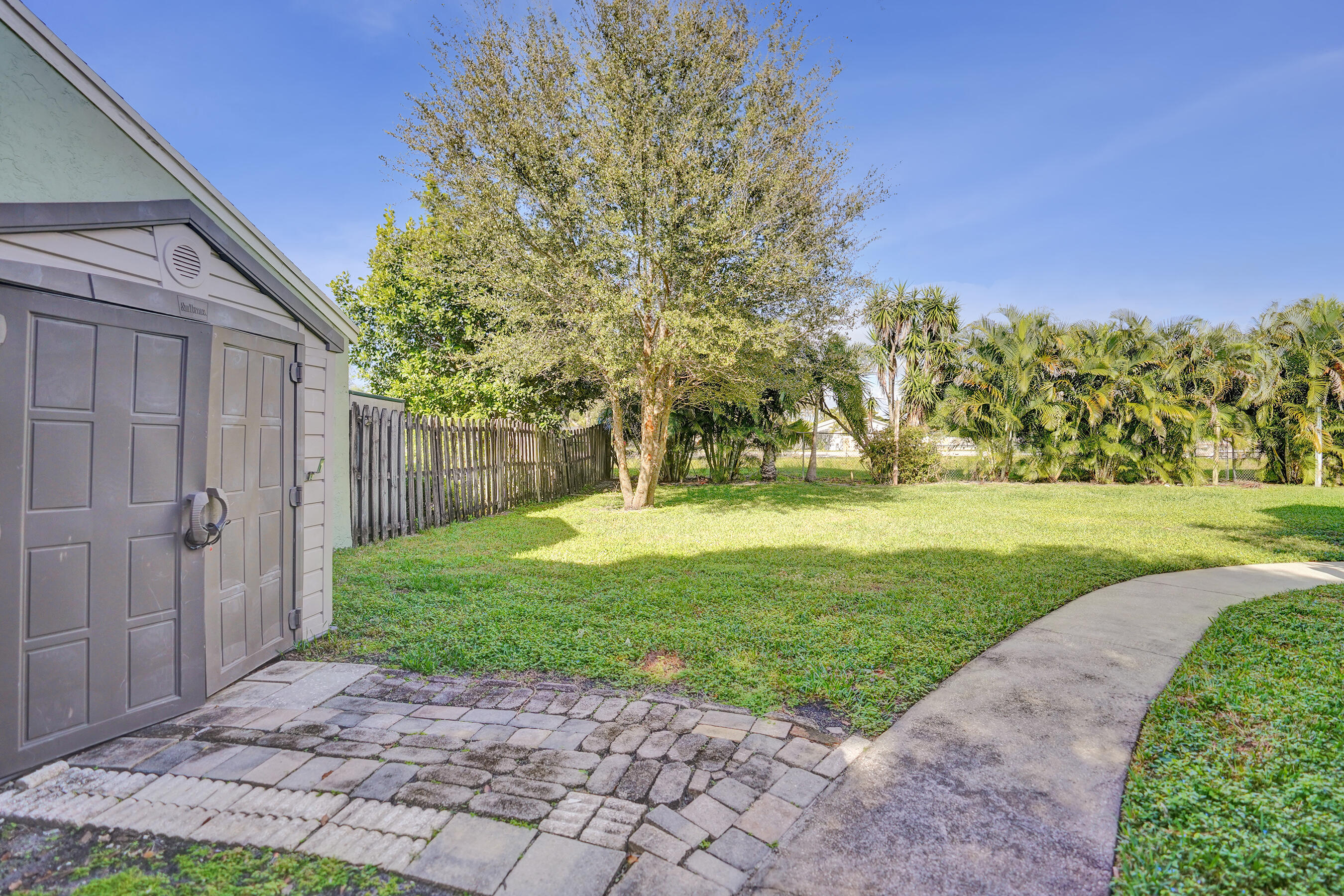 9855 Robins Nest Road Boca Raton, FL 33496 - Photo 55 of 84 a view of a yard with plants and large trees