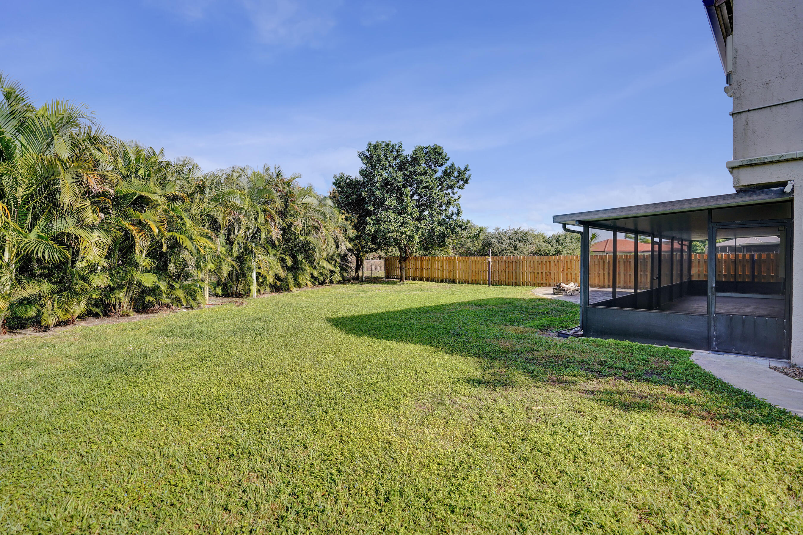9855 Robins Nest Road Boca Raton, FL 33496 - Photo 57 of 84 a view of a garden with a building in the background