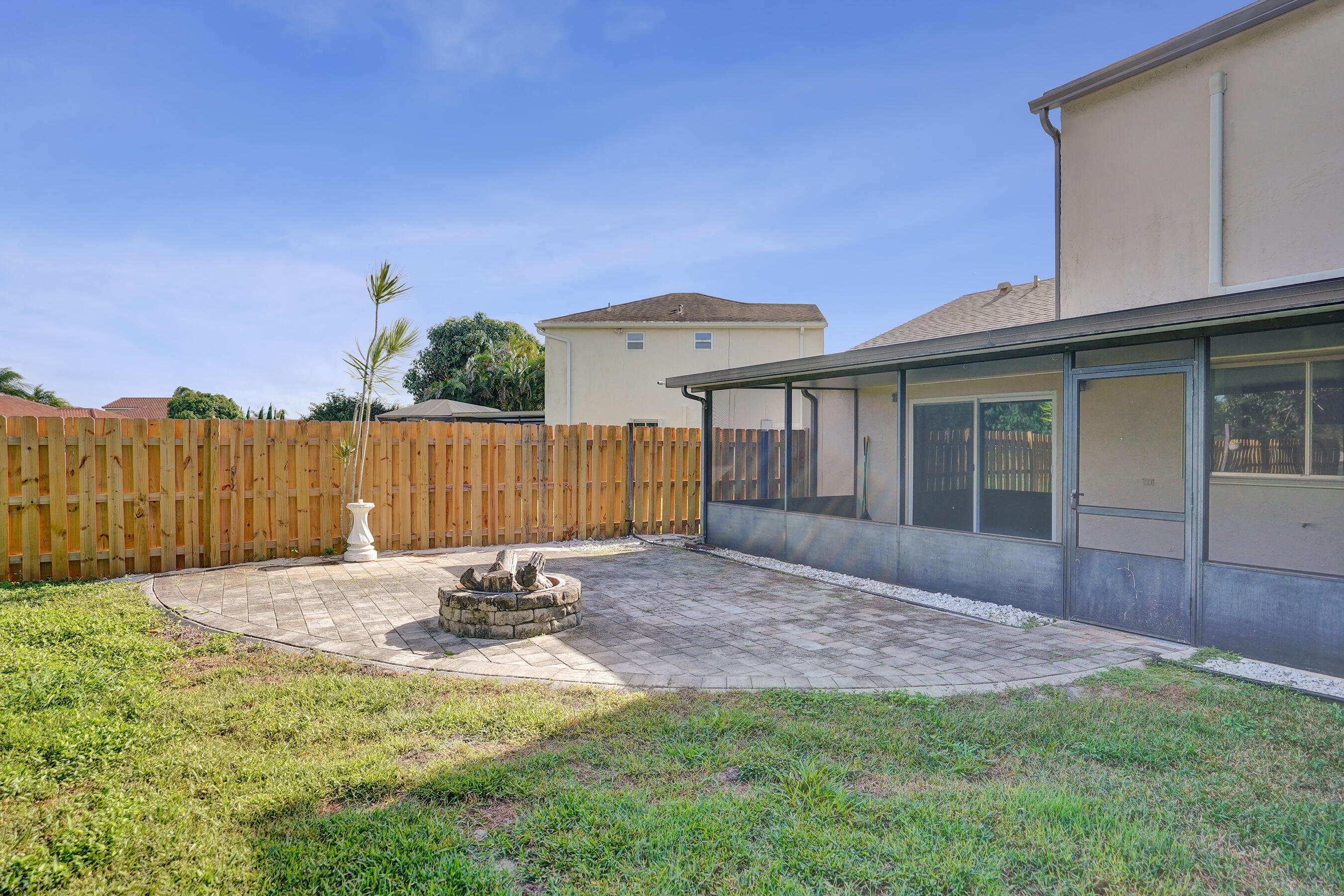 9855 Robins Nest Road Boca Raton, FL 33496 - Photo 60 of 84 a view of a house with backyard and wooden fence