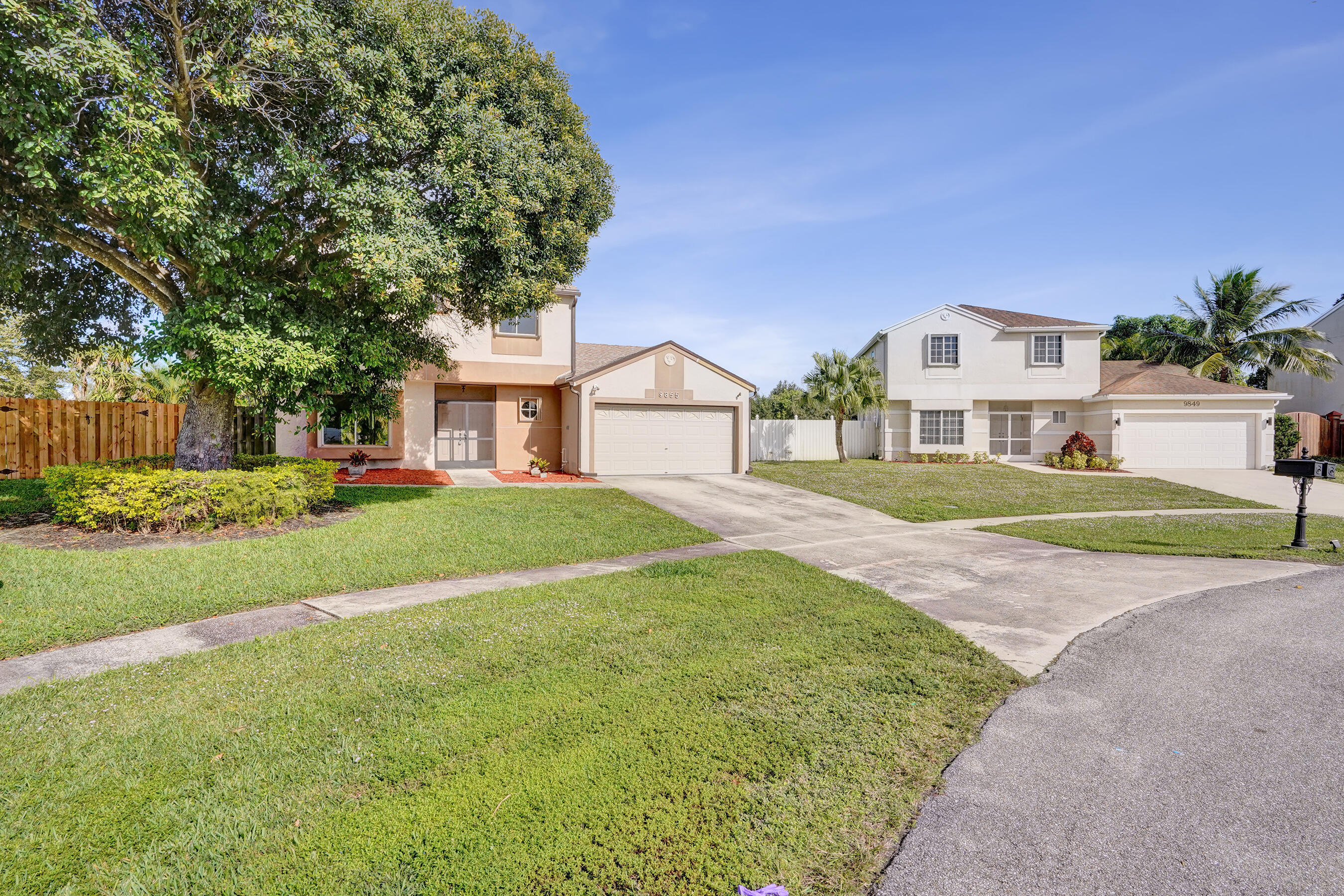 9855 Robins Nest Road Boca Raton, FL 33496 - Photo 65 of 84 a front view of a house with a yard and garage