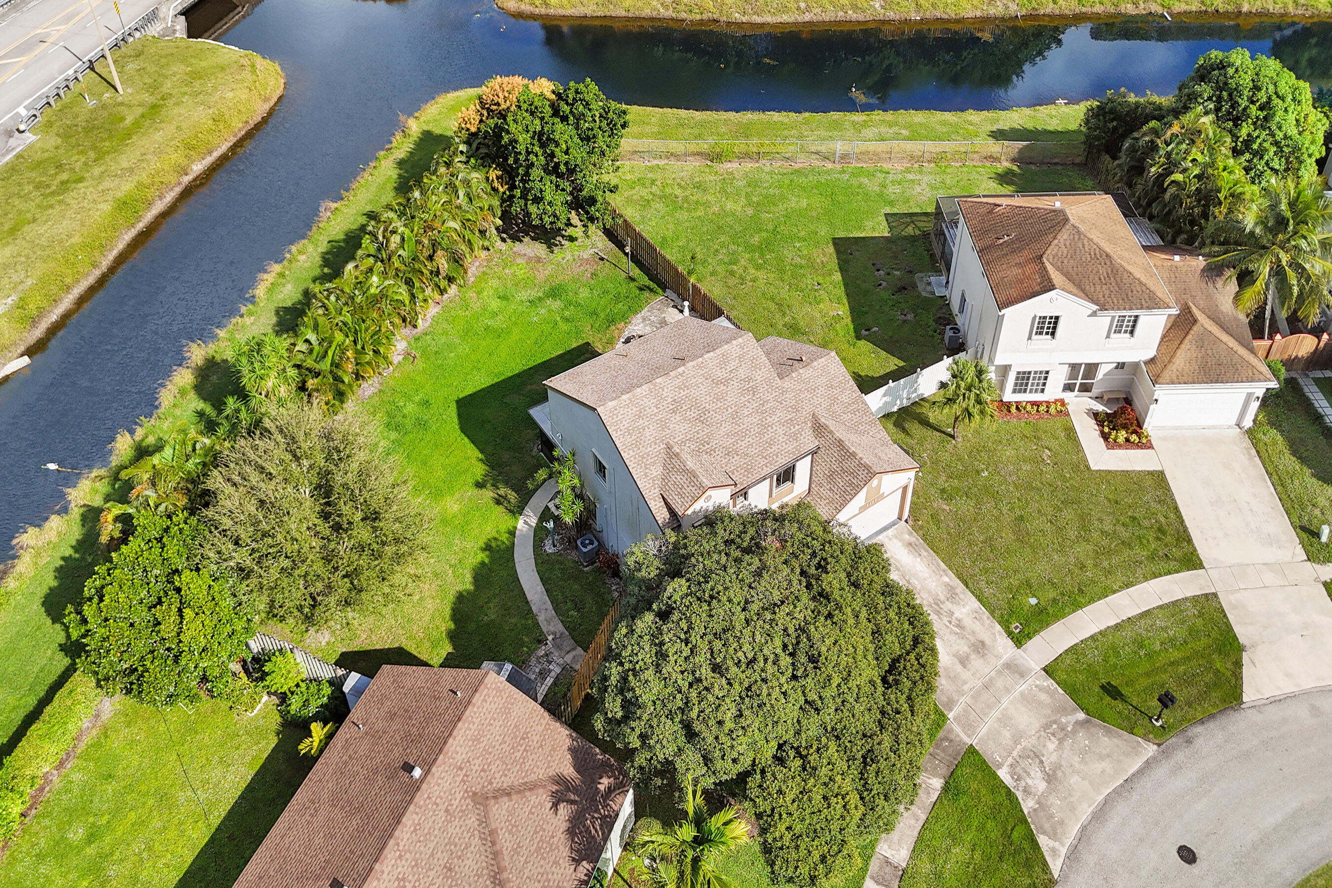 9855 Robins Nest Road Boca Raton, FL 33496 - Photo 70 of 84 an aerial view of a house with a yard and plants