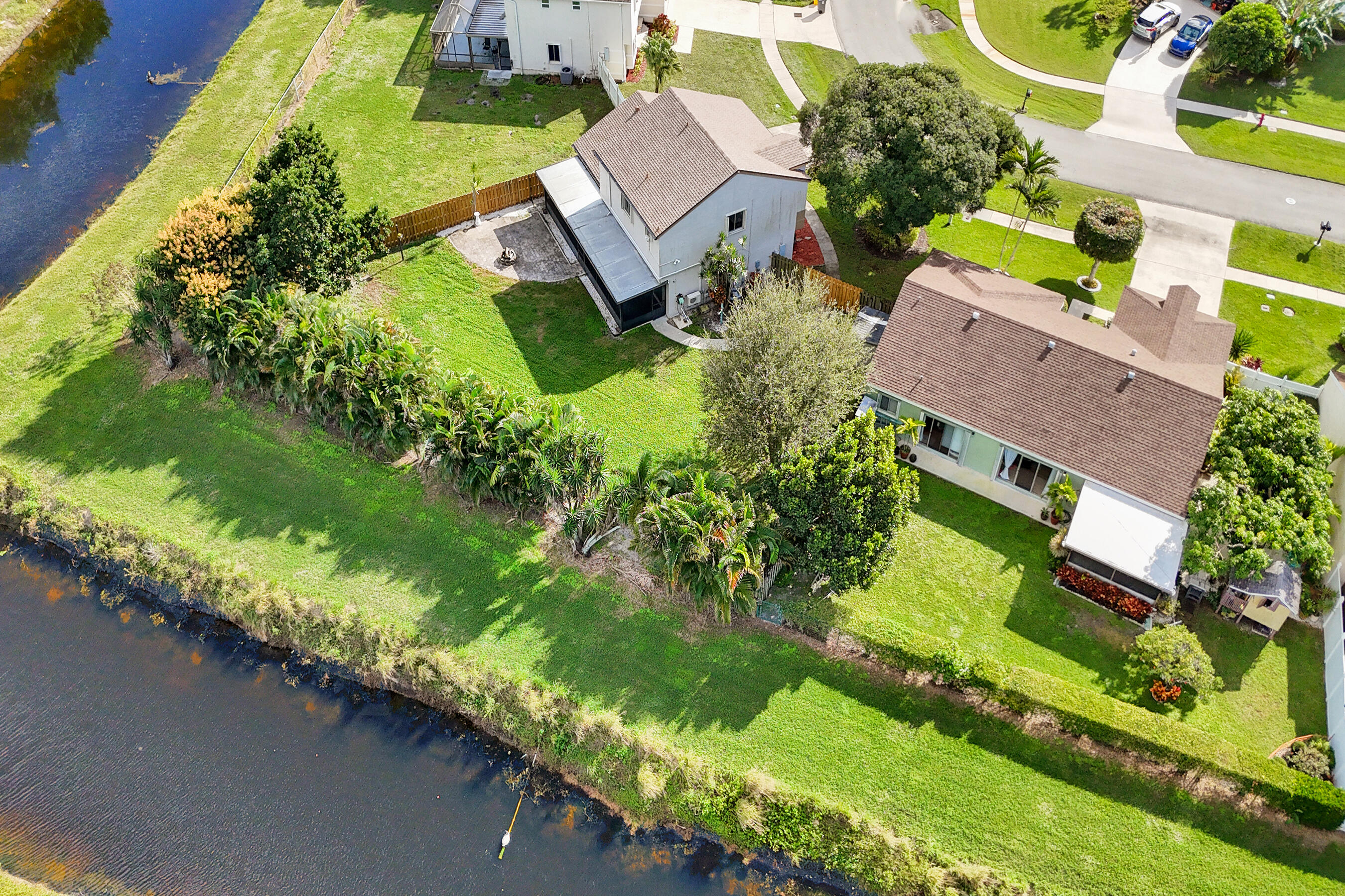 9855 Robins Nest Road Boca Raton, FL 33496 - Photo 73 of 84 an aerial view of a house with a garden and swimming pool
